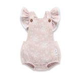 Pink baby romper with ruffled sleeves on a white background