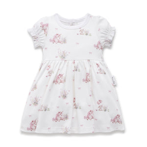 White dress with pink floral pattern on a white background