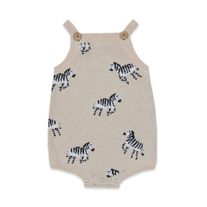 Knitted romper with zebra pattern on a white background