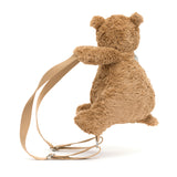 Brown teddy bear with a backpack on a white background