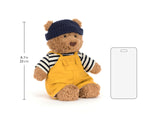 Teddy bear in yellow overalls and blue hat with dimensions and a clear screen protector on a white background