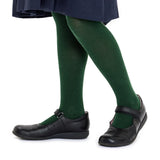 A person wearing dark green tights, a navy blue skirt, and black Mary Jane shoes, shown from the waist down against a plain white background.