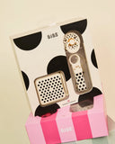 Small decorative item with a cow print pattern on a white background