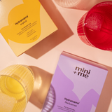 Two boxes of 'Hydramama' and 'mini + me' on a pink background with yellow and red items.