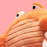 Close-up of a plush toy with a pink background