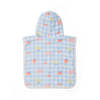 Baby poncho with cherry pattern on a blue checkered background