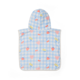 Baby poncho with cherry pattern on a blue checkered background