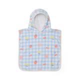Children's poncho with hood and cherry pattern on a blue checkered background