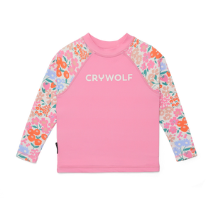 Pink long-sleeve shirt with floral sleeves and 'CRYWOLF' text on a white background