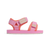 Pink and orange sandal with visible brand name on a white background