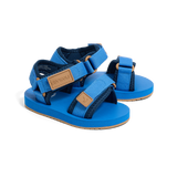 Blue children's sandals with brown straps on a white background