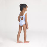 Young girl wearing a blue and white striped swimsuit on a plain background