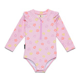 A pink long-sleeve baby swim bodysuit with a half-zip neckline, featuring an all-over pattern of small pink, orange, and yellow flowers, laid flat on a white background.