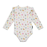 A long-sleeve baby bodysuit with a white base and a colorful seashell and starfish pattern, shown flat on a white background.