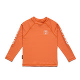 An orange long-sleeve rash guard top for kids, featuring a white circular logo on the left chest and white 'CROW' text printed down both sleeves, displayed flat against a white background.