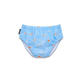 A light blue baby swim diaper with an orange and white fish pattern, featuring a waistband with snap buttons on the back and a black brand tag on the side.