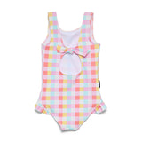 A girls' sleeveless one-piece swimsuit with a pastel pink, yellow, and light blue gingham check pattern. It features a keyhole cutout at the center chest with a matching fabric bow, and ruffled trim along the armholes and leg openings.