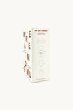 A tall, narrow white product box with minimalist brown line drawings and brown text, including the words 'WE ARE GOMMU' and large vertical letters, shown on a plain light background.