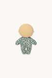 Baby doll with a green and white patterned onesie on a white background