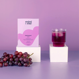 Purple candle and 'mini + me' product on a purple background