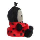 Plush ladybug toy with black and red colors on a white background