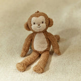 Stuffed monkey toy on a beige fabric background