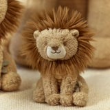 Plush lion toy with a soft texture on a beige background
