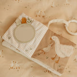 Baby blanket with duck design on a beige background