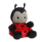 Plush ladybug toy with a smiling face on a white background