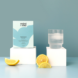 Product packaging with a glass of water and lemon slices on a light blue background