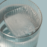 Clear glass with a textured interior against a light blue background