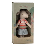 A Maileg 'mimie' plush mouse toy in its original cardboard packaging, featuring a beige mouse wearing a red and white striped shirt and a blue patterned skirt.