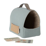 Pet carrier with a handle and a small card on a white background