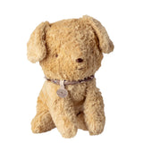Beige stuffed dog toy with a collar on a white background