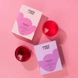 Two boxes of 'mini + me' Hydramama on a pink background with red containers.