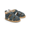 Pair of blue sandals with brown soles on a white background