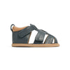 Blue children's sandal with brown sole on a white background