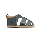Blue children's sandal with brown sole on a white background