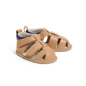 Pair of tan baby sandals on a white background