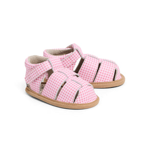 Pair of pink checkered baby sandals on a white background