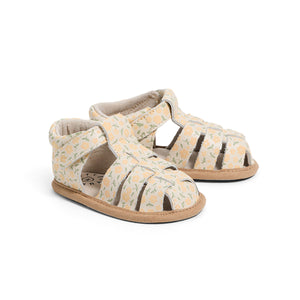 Pair of baby sandals with floral pattern on a white background