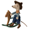 Stuffed mouse toy in cowboy outfit riding a wooden rocking horse on a white background