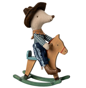 Toy mouse in cowboy outfit riding a wooden rocking horse on a white background