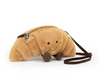 Plush toy resembling a caterpillar with a smiling face on a white background