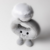 Gray plush toy with a smiling face on a white background