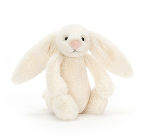 Cream-colored plush bunny toy on a white background