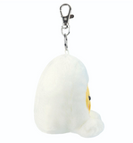 Plush keychain shaped like a white egg with a face on a white background