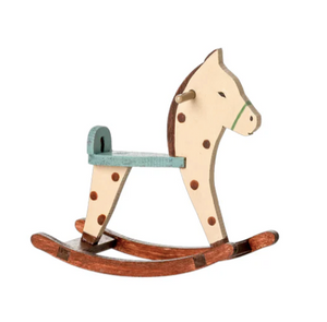 Wooden rocking horse with a white face and brown body on a white background
