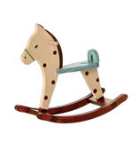 Wooden rocking horse with brown body and green reins on a white background