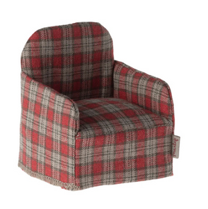 Small plaid armchair with red and gray pattern on a white background